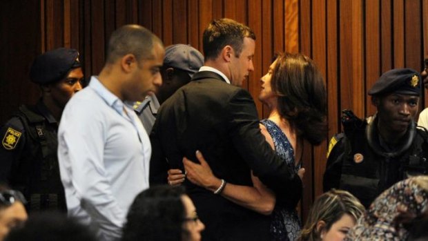 Oscar Pistorius hugs his sister Aimee inside the courtroom.