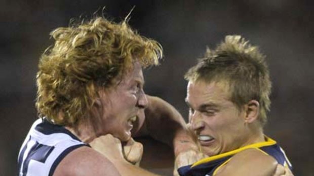Adelaide's Bernie Vince and Geelong's Cameron Ling scuffle during the second quarter.
