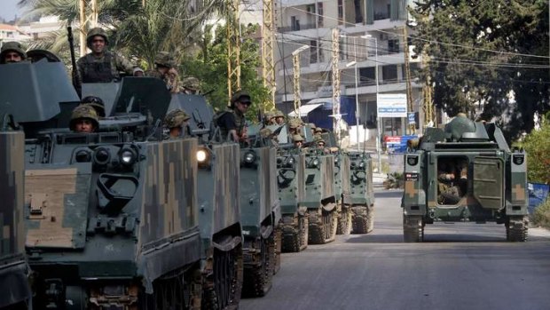 Lebanese army vehicles move toward the site of clashes between followers of a radical Sunni cleric Sheik Ahmad al-Assir and Shiite gunmen, in the southern port city of Sidon, Lebanon, Monday, June 24, 2013.