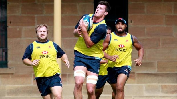 Up for it: Kane Douglas catches the ball at training on Tuesday flanked by Benn Robinson, left, and Sekope Kepu.
