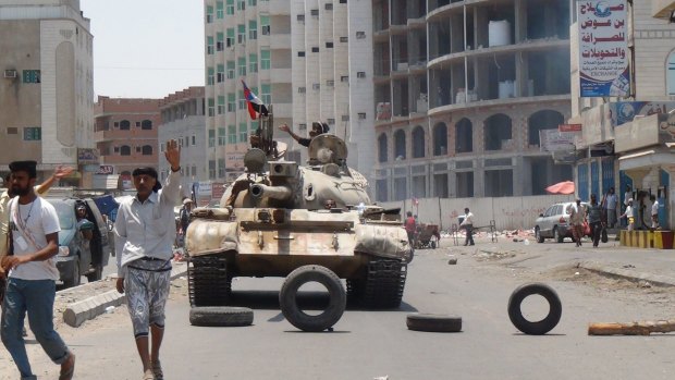 Militiamen loyal to Yemen's exiled president Abed Rabbo Mansour Hadi take positions at a street in Aden on April 2.
