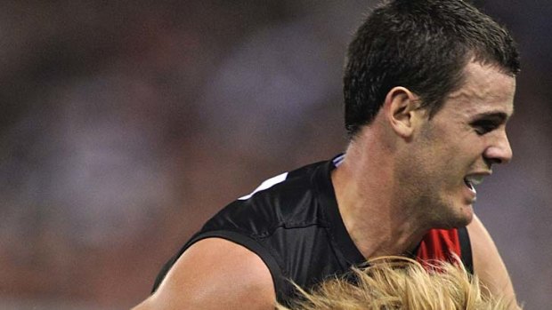 Close up: Essendon's Brent Stanton tackled by Collingwood's Dale Thomas.