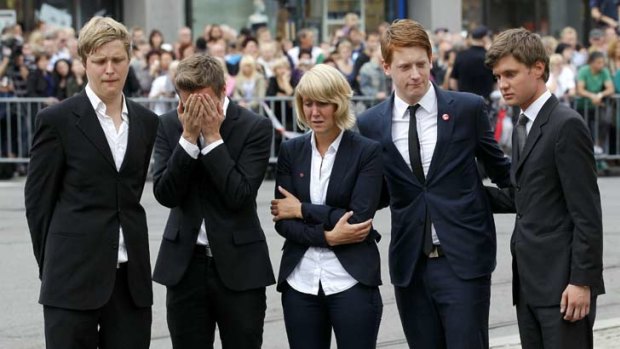 Survivors' guilt ... Survivors of the island shooting rampage break out in tears following a memorial service on Sunday.