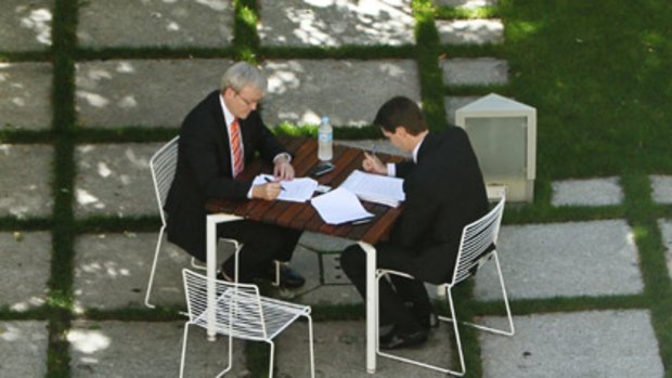 Balancing the books... after Tuesday's national health reform negotiations with state leaders, Kevin Rudd talks with his chief economic adviser, Andrew Charlton, in a quiet courtyard inside Parliament House yesterday.