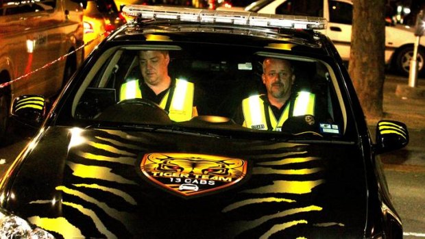 Striped for action: Greg Hardeman and ''Tony'' make up one of three cab protection teams cruising the streets.