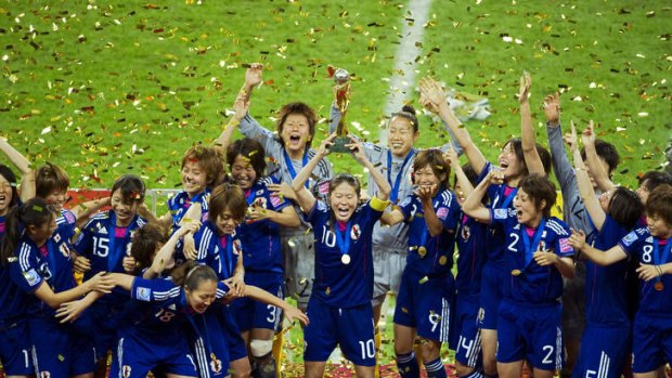 Against all odds ... the victorious Japanese players celebrate with the trophy after holding their nerve in the penalty shoot-out to win the World Cup in Germany.