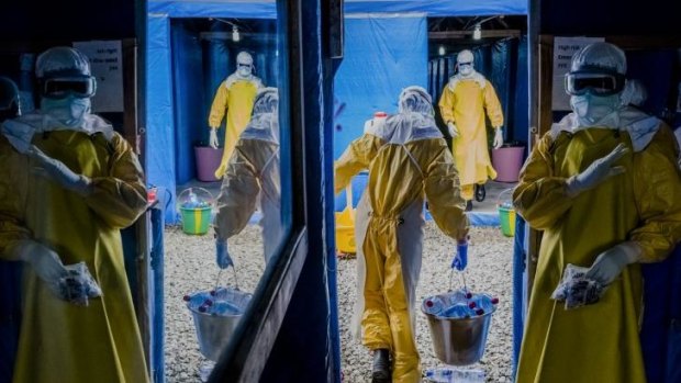 Workers enter the high-risk zone of the Bong County Ebola Treatment Unit in Suakoko, Liberia.