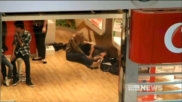 Worst-case scenario &#8230; a woman shot in bikie-related violence lies on the floor, while police investigate.