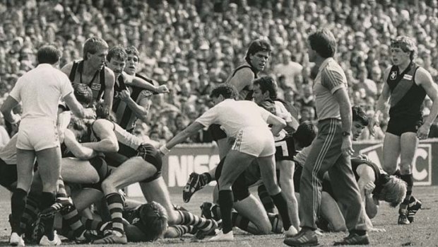 1985 VFL Grand Final, Essendon v Hawthorn, 30-09-1985. Umpires Peter Cameron and Ian Robinson move in to break up an all-in brawl minutes after the first bounce.