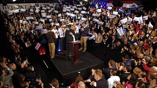 Victory night in New Hampshire for an elated Mitt Romney, surrounded by his family and a crowd of supporters at Southern New Hampshire University, Manchester.