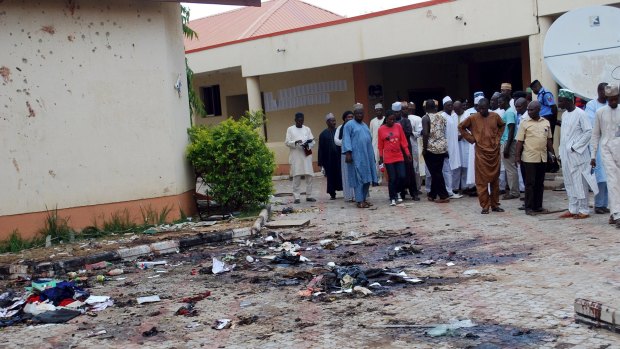 Journalists and officials gather at the scene of a bomb blast in Zaria, Nigeria on July 7. The latest bomb attack, blamed on Islamists Boko Haram, has killed at least 47 people.