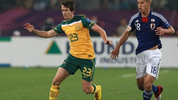 Robbie Kruse is chased by Keisuke Honda of Japan during the AFC Asian Cup Final in 2011.