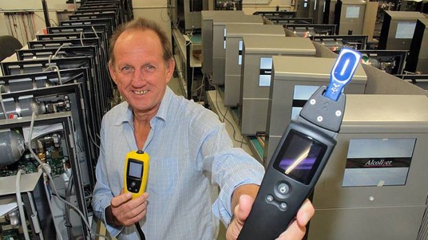 Alcolizer chief executive Gary Johnson with one of their breathalyser's (yellow) and the new unit that can test both drug and alcohol levels.