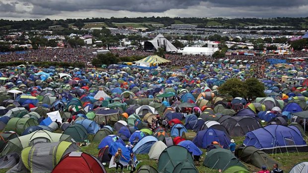 Rain clouds gather over the Pyramid Stage and tent city at Glastonbury Festival site at Worthy Farm, England.