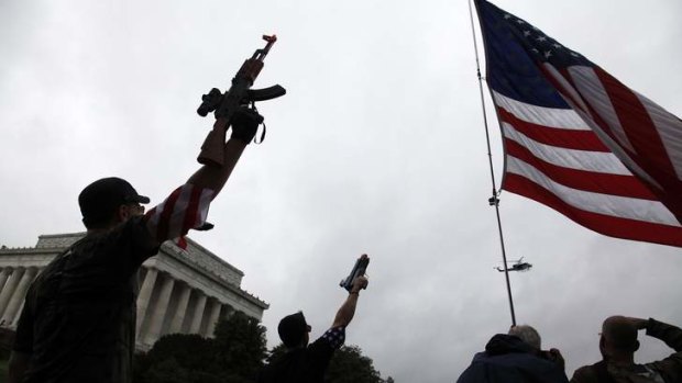 Gun culture runs deep in the US. A group of about twenty demonstrators raise their toy guns at a passing helicopter near the Lincoln Memorial as they march in a 'Toy Gun March' demonstration, organized by a Libertarian website to highlight Second Amendment gun right