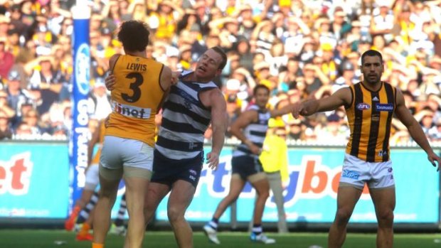 Hawthorn's Jordan Lewis and Geelong's Steve Johnson come to grips.