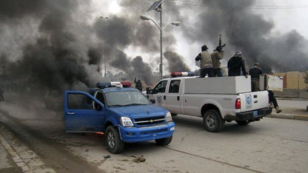 Violence: Al-Qaeda fighters patrol in a commandeered police truck in Fallujah, Iraq. 
