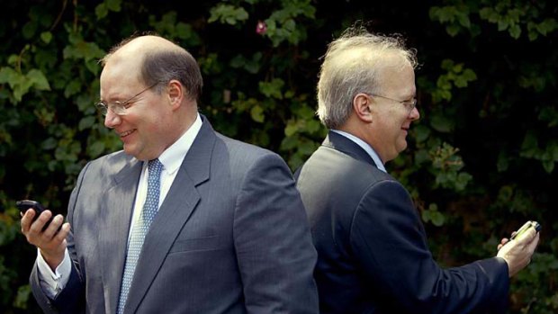 White House deputy chief of staff for President George W. Bush, Joe Hagen , left, and Bush's senior advisor, Karl Rove, keep up to date on their BlackBerry devices in 2006.