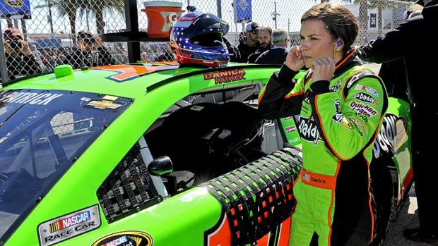 Danica Patrick exits her vehicle after her Daytona 500 pole position-securing run during qualifying.