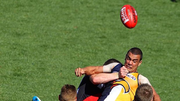 Daniel Kerr is tackled by Heath Hocking during the game between West Coast and Essendon.