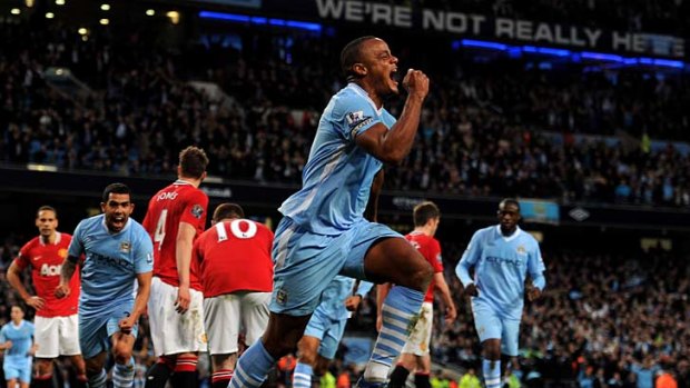 Manchester City captain Vincent Kompany celebrates scoring the opening goal.