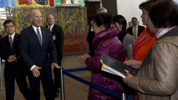 US Vice-President Joe Biden (centre) and US ambassador to China Gary Locke (left) meet visa applicants at the US Embassy Consular Section in Beijing. 