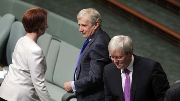 Carnage: Julia Gillard walks past Simon Crean and Kevin Rudd at the end of question time.