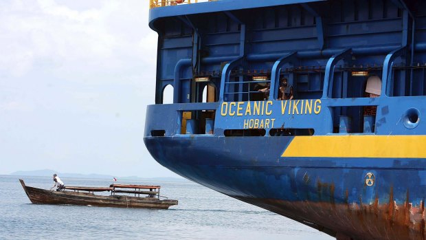 The Australian customs vessel the Oceanic Viking, carrying Sri Lankan asylum seekers, and a traditional Indonesian boat off Bintan Island, Indonesia in October 2009. 