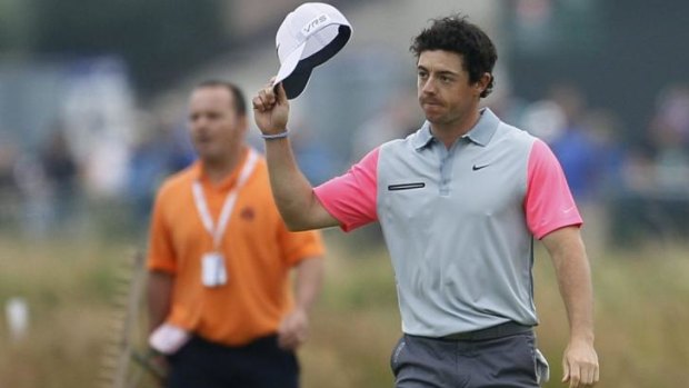 Rory McIlroy acknowledges the crowd as he walks up to the 18th green to claim the British Open at Hoylake.