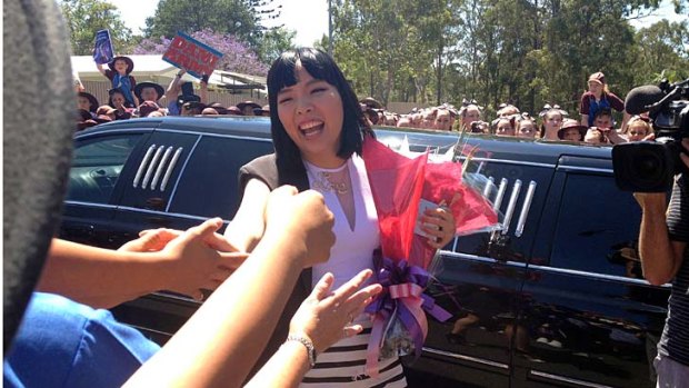 X Factor star Dami Im greets students at her former school.