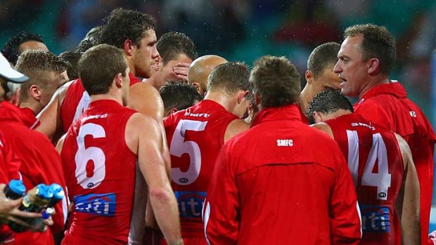 Team to beat: The Swans with coach John Longmire during a break in the game against Essendon.