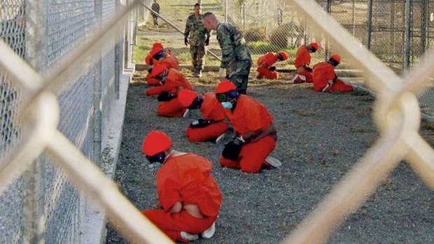 Detainees sit in a holding area  at Guantanamo Bay.