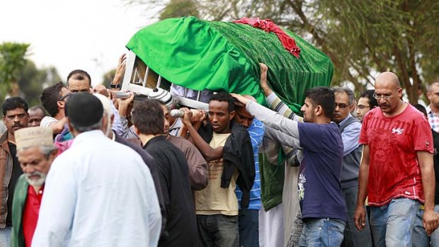 Relatives and Muslim faithful carry the slain body of Rehmad Mehbub, 18, who was killed in a crossfire between armed men and the police at the Westgate shopping mall.