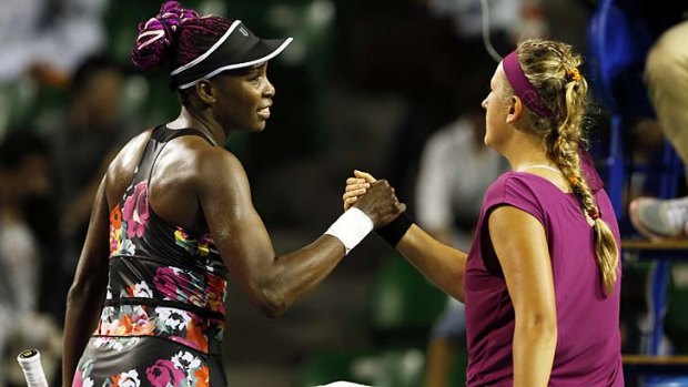 Venus Williams shakes hand with Victoria Azarenka after their women's singles match at the Pan Pacific Open in Tokyo.