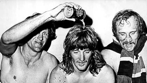 Ron Coote pours a drink over Russell Fairfax's head as a happy Mark Harris looks on after Eastern Suburbs won the Rugby League grand final at the SCG in 1974,  beating Canterbury 19-4.