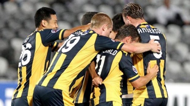 Time to celebrate: Mariners players congratulate veteran Mile Sterjovski after scoring against Hiroshima.