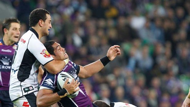 Plenty of pressure: Storm's Adam Blair is tackled high and low during the loss to the Warriors.