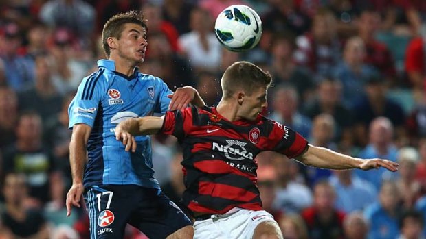 Sydney FC's Terry Antonis competes for the ball against Shannon Cole of the Wanderers.