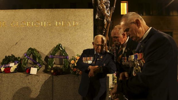 Timing the moment ... chief cenotaph attendant of 67 years Wal Scott-Smith, Vietnam veteran Ron Webb, and Malaya veteran Kel Ratcliff wait at the Martin Place war memorial in Sydney for the beginning of ANZAC day dawn service.