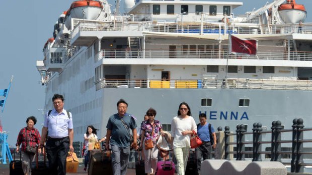 Passengers leave the Chinese cruise Henna for Jeju airport, South Korea.