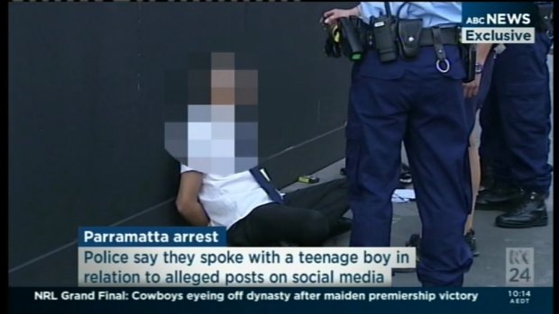 Police arrest a student outside Arthur Phillip High School.