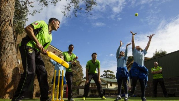 Willow key: Mike Hussey and his Sydney Thunder teammates at Annandale Public School on Wednesday.