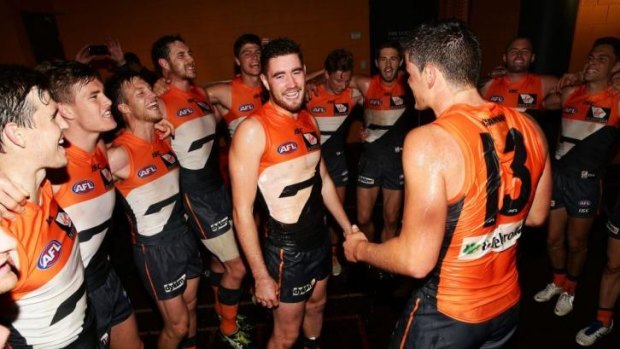 Kristian Jaksch (left) and Tom Boyd (right) of the Giants celebrate with teammates after defeating Carlton on Sunday.