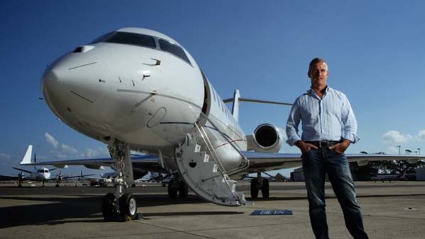 Fight plans . . . Tabcorp's Larry Mullin with the Bombardier Global express XRS corporate jet, so luxurious even Jon Bon Jovi wants one.