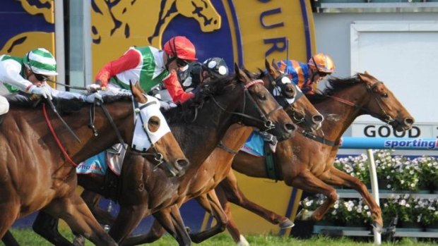 Like a boss: Rebel Dane (red cap) charges late to win the Rupert Clarke Stakes at Caulfield in September.