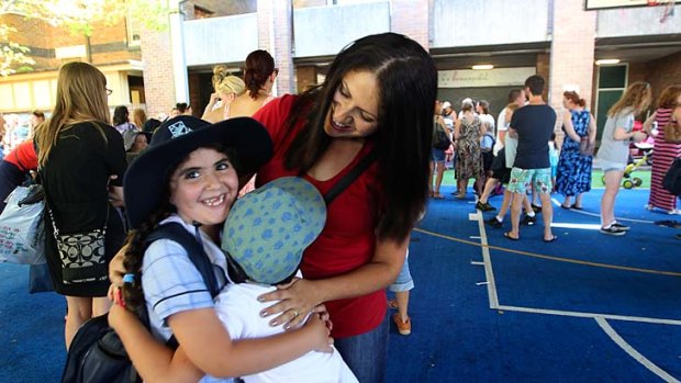 She's an old hand: Maria Kyriacou with her five-year-old son George, picking up her daughter Maia at Stanmore.