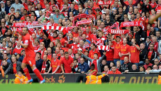 Fans of Liverpool waving flags during their team's clash with  Manchester United at Anfield early this month.
