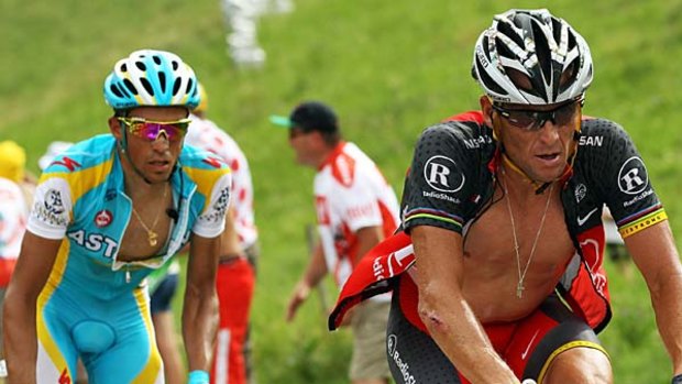 Alberto Contador, left, follows the wheel of Lance Armstrong.