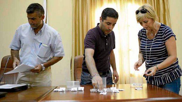 Mayor Juan Lorenzo Pineda Claverias (centre) conducts a municipal job lottery for the unemployed in Alameda, Spain.