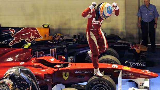 Fernando Alonso of Spain celebrates his victory in the Singapore Grand Prix.